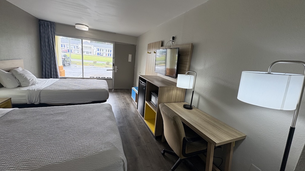 In-room amenities view including flat‑screen TV and work desk area.